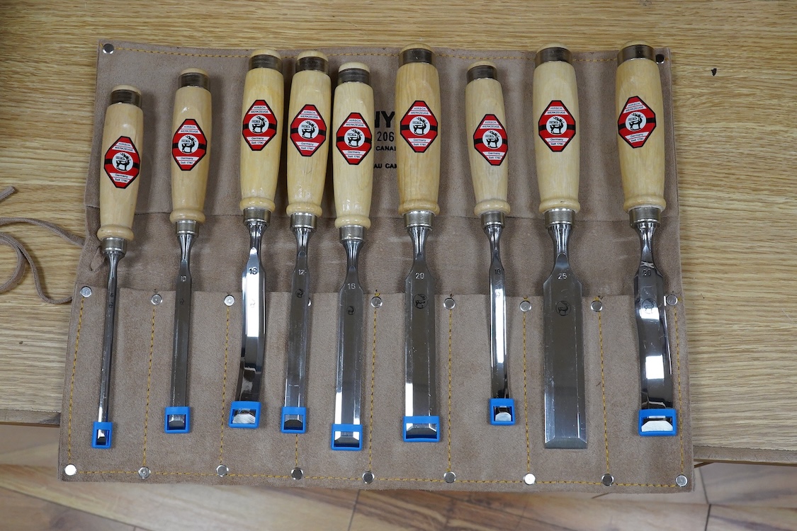 Three sets of woodworking chisels, including a cased six piece set by Seit, Germany, a nine piece set by Herschel, Germany, in a leather roll and a Swiss made nine piece set also in a leather roll